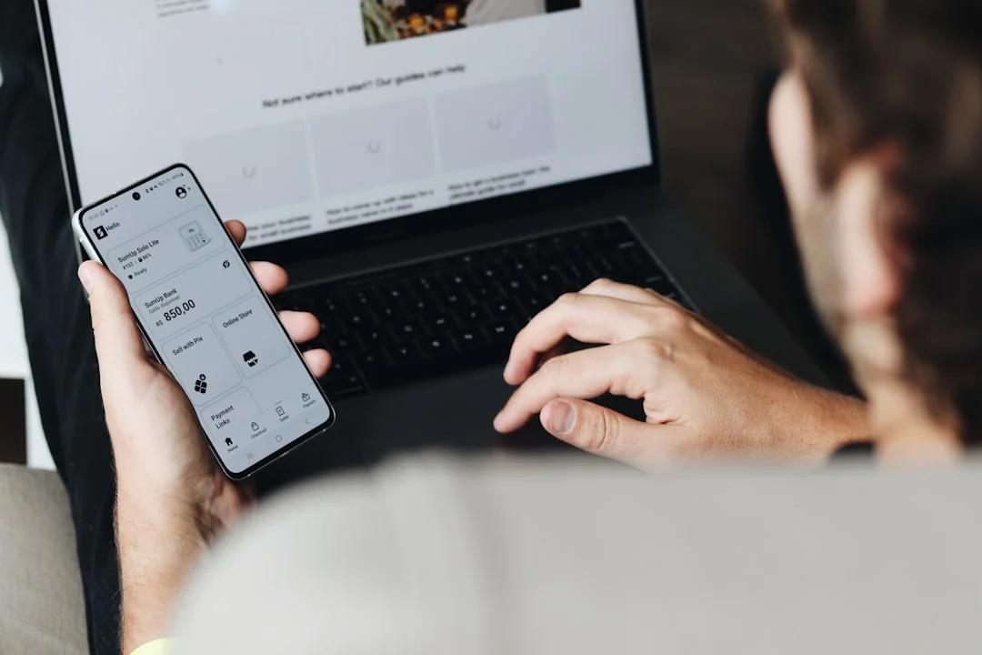 A smartphone in a miniature cart on a laptop symbolizes online shopping and digital payment.